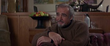 Movie still from “The Russia House” (1990), directed by Fred Schepisi – An older man sitting in front of a bowl of fruit; Close Up shot, Over the shoulder angle