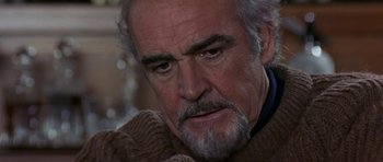 Movie still from “The Russia House” (1990), directed by Fred Schepisi – A person wearing a sweater; Close Up shot, Over the shoulder angle