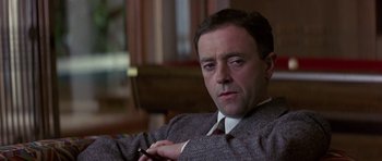 Movie still from “The Russia House” (1990), directed by Fred Schepisi – A person wearing a suit and tie; Close Up shot, Low angle