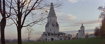 Movie still from “The Russia House” (1990), directed by Fred Schepisi – A large white church with a steeple on top of a hill; Extreme Wide shot, Low angle
