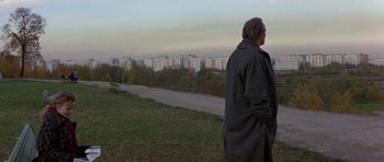 Movie still from “The Russia House” (1990), directed by Fred Schepisi – An older man standing on a hill overlooking a city; Wide shot, High angle