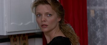 Movie still from “The Russia House” (1990), directed by Fred Schepisi – A person wearing a black shirt; Close Up shot, Over the shoulder angle