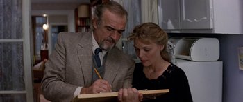 Movie still from “The Russia House” (1990), directed by Fred Schepisi – An older man and a younger woman looking at a piece of wood; Close Up shot, Low angle