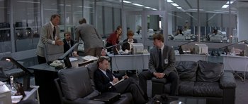 Movie still from “The Russia House” (1990), directed by Fred Schepisi – A group of people sitting in a room; Wide shot, High angle