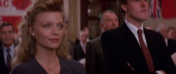 Movie still from “The Russia House” (1990), directed by Fred Schepisi – A group of people sitting in a room; Close Up shot, Over the shoulder angle