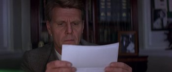 Movie still from “The Russia House” (1990), directed by Fred Schepisi – A person holding a paper in his hands; Close Up shot, Low angle