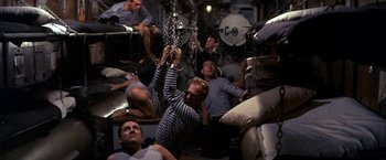 Movie still from “The Russians Are Coming the Russians Are Coming” (1966), directed by Norman Jewison – A group of men sitting on top of a boat; Wide shot, Overhead angle