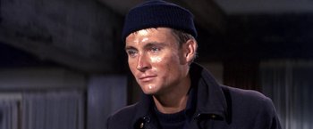 Movie still from “The Russians Are Coming the Russians Are Coming” (1966), directed by Norman Jewison – A person wearing a jacket and a hat; Close Up shot, High angle