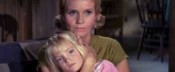 Movie still from “The Russians Are Coming the Russians Are Coming” (1966), directed by Norman Jewison – An older woman holding a young girl in her arms; Close Up shot, Low angle