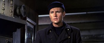 Movie still from “The Russians Are Coming the Russians Are Coming” (1966), directed by Norman Jewison – A man wearing a hat and a jacket; Close Up shot, Low angle