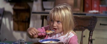 Movie still from “The Russians Are Coming the Russians Are Coming” (1966), directed by Norman Jewison – A little girl eating cereal with a spoon; Close Up shot, Over the shoulder angle