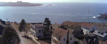 Movie still from “The Russians Are Coming the Russians Are Coming” (1966), directed by Norman Jewison – An aerial view of houses on the shore of a body of water; Extreme Wide shot, High angle