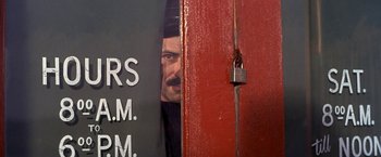 Movie still from “The Russians Are Coming the Russians Are Coming” (1966), directed by Norman Jewison – A man peeks out from behind a red door; Close Up shot, Low angle