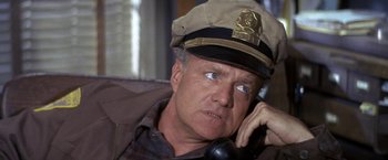 Movie still from “The Russians Are Coming the Russians Are Coming” (1966), directed by Norman Jewison – A person wearing a hat on the phone; Close Up shot, High angle