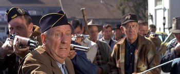 Movie still from “The Russians Are Coming the Russians Are Coming” (1966), directed by Norman Jewison – A group of men standing next to each other holding guns; Close Up shot, Over the shoulder angle