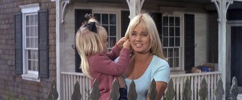 Movie still from “The Russians Are Coming the Russians Are Coming” (1966), directed by Norman Jewison – A little girl putting a headband on her mother's head; Close Up shot, Over the shoulder angle