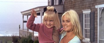 Movie still from “The Russians Are Coming the Russians Are Coming” (1966), directed by Norman Jewison – A woman and a child waving at the camera; Close Up shot, Low angle