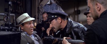 Movie still from “The Russians Are Coming the Russians Are Coming” (1966), directed by Norman Jewison – A group of men standing next to each other holding guns; Close Up shot, Over the shoulder angle