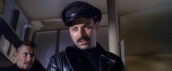 Movie still from “The Russians Are Coming the Russians Are Coming” (1966), directed by Norman Jewison – A person wearing a hat and a leather jacket; Close Up shot, Low angle