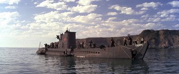 Movie still from “The Russians Are Coming the Russians Are Coming” (1966), directed by Norman Jewison – A group of people standing on the side of a boat in the water; Extreme Wide shot, High angle