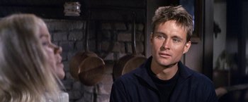 Movie still from “The Russians Are Coming the Russians Are Coming” (1966), directed by Norman Jewison – A person in a room near a fireplace; Close Up shot, Over the shoulder angle