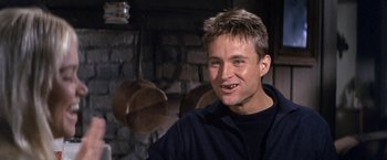 Movie still from “The Russians Are Coming the Russians Are Coming” (1966), directed by Norman Jewison – A young man smiling for the camera in front of a brick wall; Close Up shot, Low angle