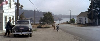 Movie still from “The Russians Are Coming the Russians Are Coming” (1966), directed by Norman Jewison – A woman and a child running down a street; Wide shot, High angle