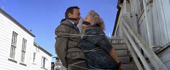 Movie still from “The Russians Are Coming the Russians Are Coming” (1966), directed by Norman Jewison – A man and a woman tied to a post; Medium shot, High angle