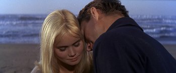 Movie still from “The Russians Are Coming the Russians Are Coming” (1966), directed by Norman Jewison – A man and a woman face to face with their eyes closed; Close Up shot, High angle