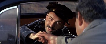 Movie still from “The Russians Are Coming the Russians Are Coming” (1966), directed by Norman Jewison – A person wearing a hat; Close Up shot, Over the shoulder angle