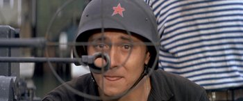 Movie still from “The Russians Are Coming the Russians Are Coming” (1966), directed by Norman Jewison – A man wearing a red star helmet and a microphone; Close Up shot, Low angle
