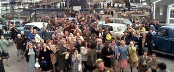 Movie still from “The Russians Are Coming the Russians Are Coming” (1966), directed by Norman Jewison – A large group of people are gathered on the street; Wide shot, High angle