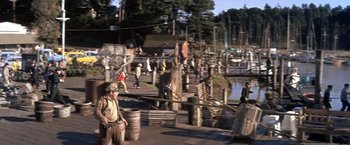 Movie still from “The Russians Are Coming the Russians Are Coming” (1966), directed by Norman Jewison – A group of people standing on top of a dock; Extreme Wide shot, High angle