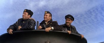 Movie still from “The Russians Are Coming the Russians Are Coming” (1966), directed by Norman Jewison – A group of men sitting on top of a boat; Medium shot, Low angle