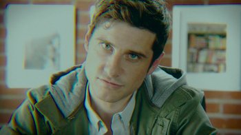 Movie still from “The Sacrament” (2013), directed by Ti West – A person wearing a jacket; Close Up shot, Over the shoulder angle