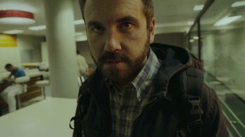 Movie still from “The Sacrament” (2013), directed by Ti West – A person wearing a jacket; Close Up shot, Low angle