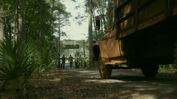 Movie still from “The Sacrament” (2013), directed by Ti West – A group of people walking down a dirt road; Extreme Wide shot, High angle