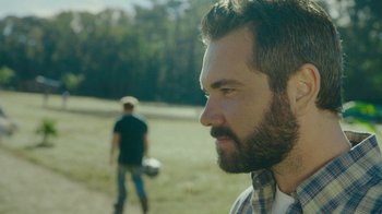 Movie still from “The Sacrament” (2013), directed by Ti West – A person with a beard; Close Up shot, Over the shoulder angle