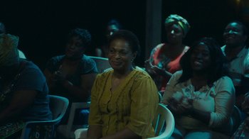 Movie still from “The Sacrament” (2013), directed by Ti West – A group of people sitting in chairs in a room; Medium shot, Over the shoulder angle