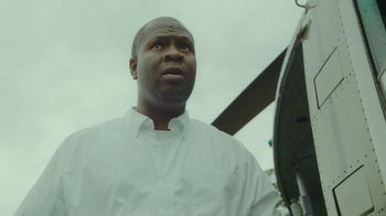 Movie still from “The Sacrament” (2013), directed by Ti West – A person wearing a white shirt; Close Up shot, Low angle