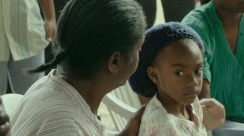 Movie still from “The Sacrament” (2013), directed by Ti West – An older woman and a young girl looking at each other; Close Up shot, Over the shoulder angle