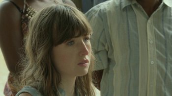 Movie still from “The Sacrament” (2013), directed by Ti West – A person with long brown hair; Close Up shot, Over the shoulder angle