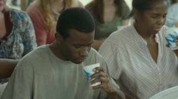 Movie still from “The Sacrament” (2013), directed by Ti West – A man holding a cup of coffee in his hand; Close Up shot, Over the shoulder angle