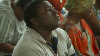 Movie still from “The Sacrament” (2013), directed by Ti West – A man in a white shirt and a blue neck tie; Close Up shot, High angle