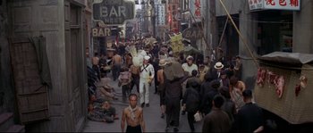 Movie still from “The Sand Pebbles” (1966), directed by Robert Wise – A crowd of people walking down a street; Wide shot, High angle