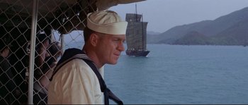Movie still from “The Sand Pebbles” (1966), directed by Robert Wise – A man in a sailor's uniform looking out over the ocean; Medium shot, Low angle