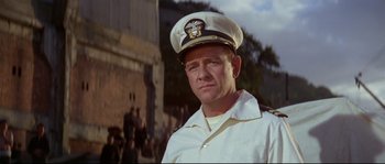 Movie still from “The Sand Pebbles” (1966), directed by Robert Wise – A man in a white uniform and a hat; Close Up shot, Low angle