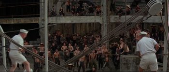 Movie still from “The Sand Pebbles” (1966), directed by Robert Wise – A large group of men in black shirts and black pants; Extreme Wide shot, High angle