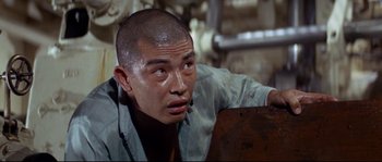 Movie still from “The Sand Pebbles” (1966), directed by Robert Wise – A person with a shaved head; Close Up shot, Low angle