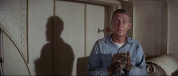 Movie still from “The Sand Pebbles” (1966), directed by Robert Wise – A man holding a bunch of wool in his hands; Medium shot, Low angle